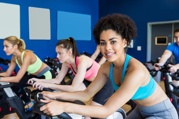 Fit people in a spin class at the gym